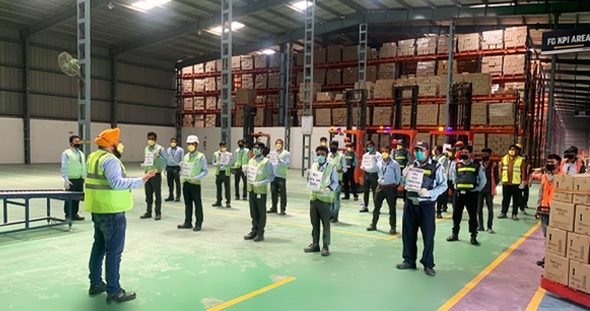 Warehouse team gathered for a morning briefing